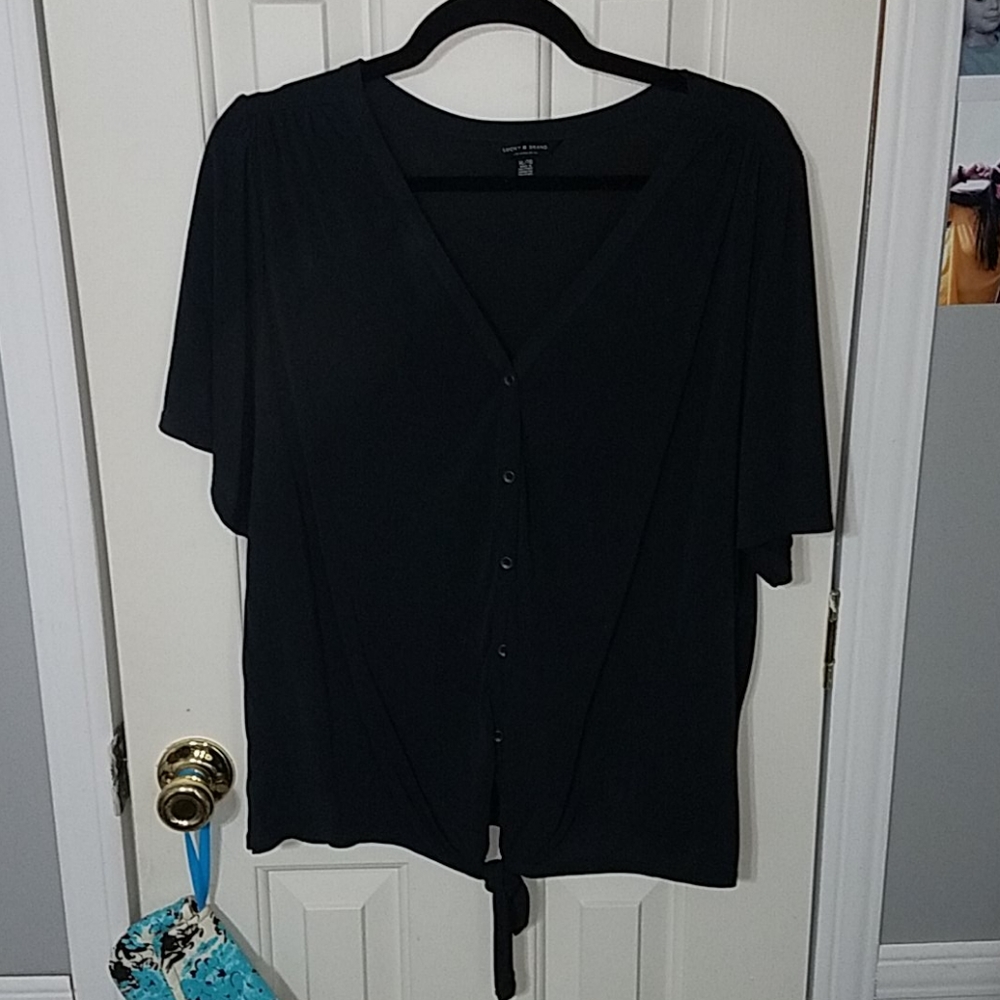 black button up shirt with a tie at the bottom